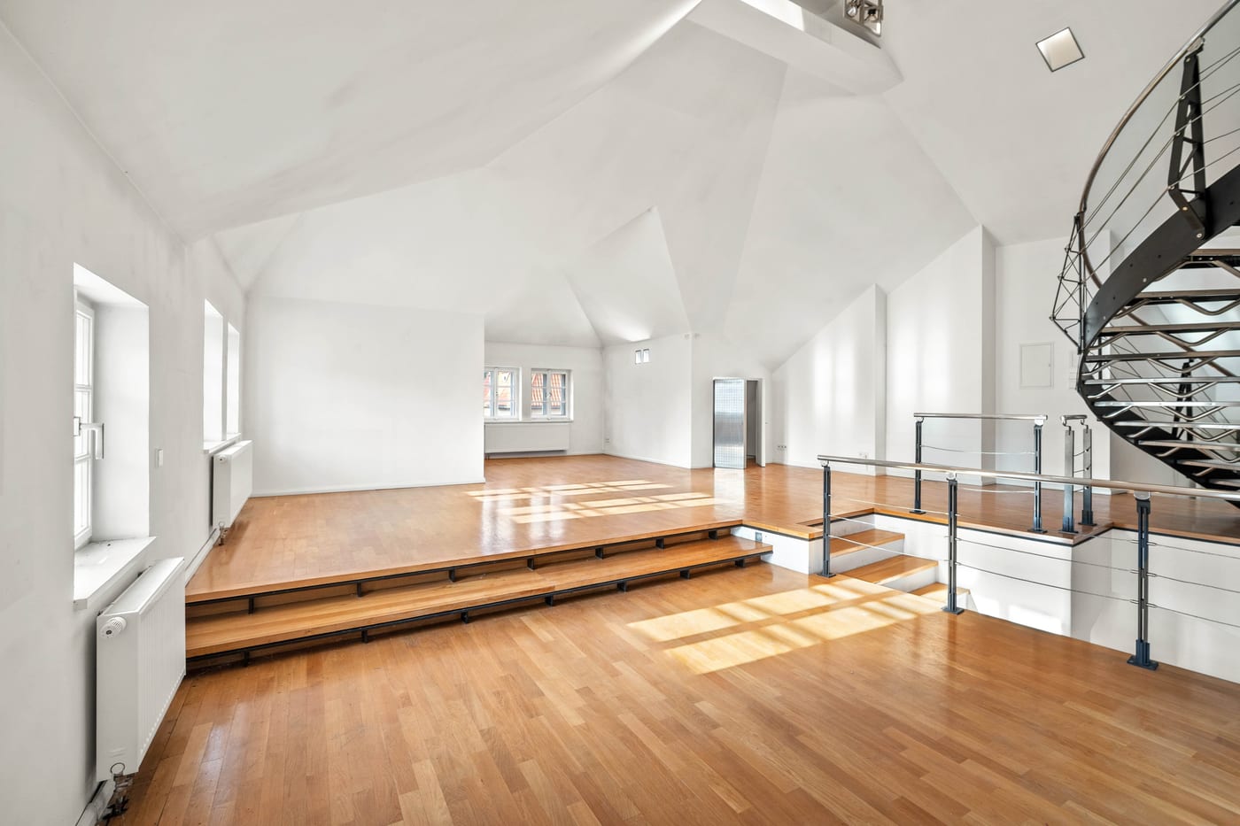 Attic: hall with oak floor, a raised platform and the spiral staircase