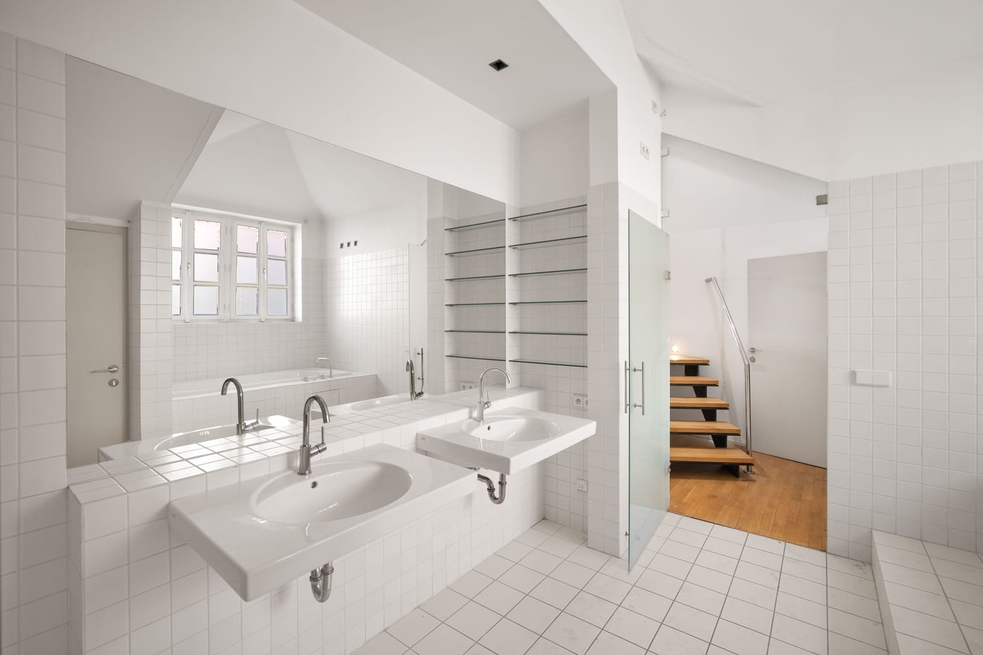 White bathroom with two basins, a window and a shower