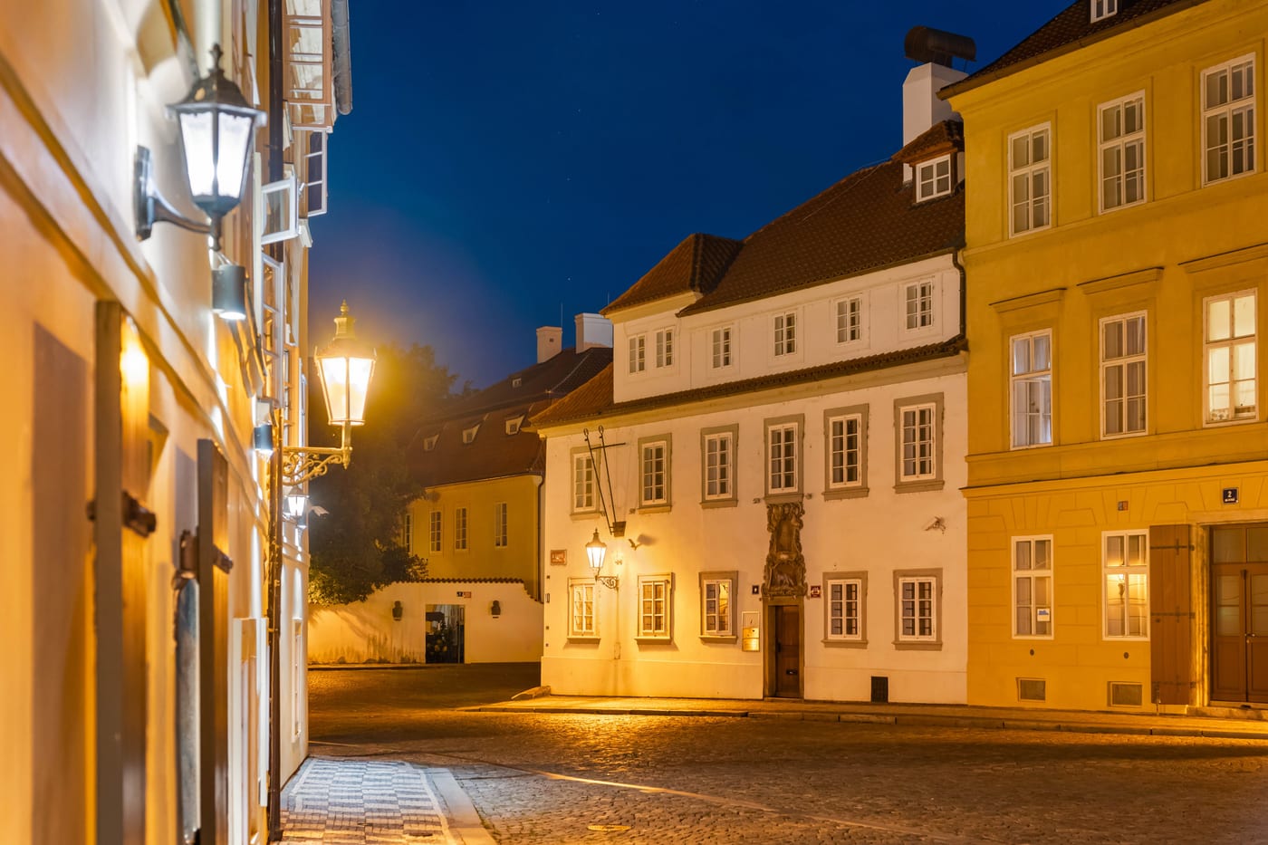 Na Kampě street in the evening, a gas lamp and the lit facade of the house